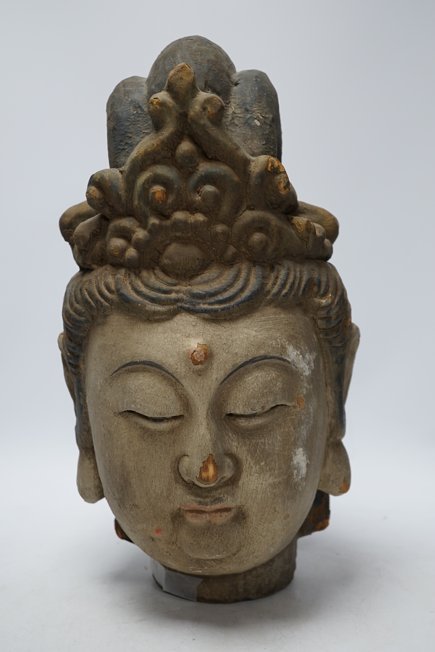 A Chinese painted wood head of Guanyin, Yuan style, 40cm